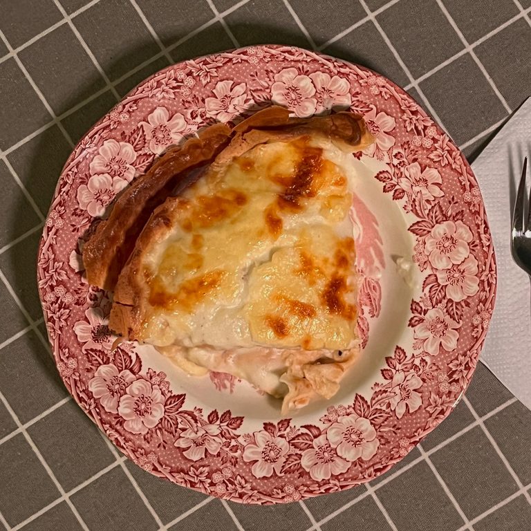 Crêpes stuffed with Fontina cheese and ham, served in a deep plate.
